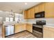 Bright kitchen featuring stainless steel appliances, wood cabinets, and white countertops at 9763 Rolling Plain Dr, Noblesville, IN 46060
