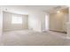 Expansive living room featuring neutral carpet, recessed lighting, and a large window at 9763 Rolling Plain Dr, Noblesville, IN 46060