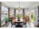 Bright dining room features hardwood floors, round table with chairs, and large windows for plenty of natural light at 9847 Bryce Blvd, Pendleton, IN 46064