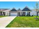 Charming home featuring blue siding, brick accents, a well-manicured lawn, and inviting curb appeal at 9847 Bryce Blvd, Pendleton, IN 46064