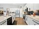 Modern kitchen with white cabinets, stainless steel appliances, and stylish black backsplash at 9847 Bryce Blvd, Pendleton, IN 46064