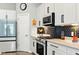 Close-up of a modern kitchen featuring white cabinets, stainless steel appliances, and a stylish backsplash at 9847 Bryce Blvd, Pendleton, IN 46064