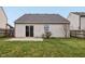 The backyard has a small patio and is surrounded by grass and a wood privacy fence at 10861 Tealpoint Dr, Indianapolis, IN 46229