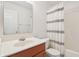 Clean bathroom featuring a vanity with sink, a toilet, a mirror, and a shower with patterned curtain at 10861 Tealpoint Dr, Indianapolis, IN 46229