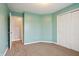Inviting bedroom with refreshing green walls, soft carpeting, a bright window, and ample closet space at 10861 Tealpoint Dr, Indianapolis, IN 46229