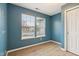 Cozy bedroom with calming blue walls, a bright window, and ample natural light showcasing comfortable living space at 10861 Tealpoint Dr, Indianapolis, IN 46229