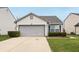 Charming single-story home with a two-car garage, neat landscaping, and inviting curb appeal at 10861 Tealpoint Dr, Indianapolis, IN 46229