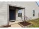 Inviting entryway with a dark blue front door, neutral siding, and tidy landscaping at 10861 Tealpoint Dr, Indianapolis, IN 46229