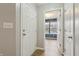 Bright hallway entrance showcasing clean white doors and trim, and inviting access to a room with natural light at 10861 Tealpoint Dr, Indianapolis, IN 46229