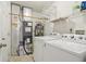 A functional laundry room with updated machines and shelving for storage at 10861 Tealpoint Dr, Indianapolis, IN 46229