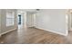 Bright and airy living room with light-colored flooring, neutral walls, and a view into the hallway at 10861 Tealpoint Dr, Indianapolis, IN 46229