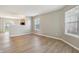 Open-concept living area featuring light-colored flooring, neutral walls, and a view into the kitchen at 10861 Tealpoint Dr, Indianapolis, IN 46229