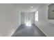 A finished basement featuring painted walls, concrete flooring, a door, and a window providing natural light at 1125 N Colorado Ave, Indianapolis, IN 46201