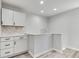 Modern kitchenette featuring white cabinets and a stylish backsplash at 1125 N Colorado Ave, Indianapolis, IN 46201