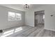 Bright living room featuring light-colored floors, a large window, and an open design to other rooms at 1125 N Colorado Ave, Indianapolis, IN 46201