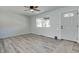 Bright, open living room with hardwood floors, fresh paint, modern ceiling fan, and ample natural light at 1125 N Colorado Ave, Indianapolis, IN 46201