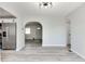 Bright living room showcasing light-colored floors and an open-concept design leading to the kitchen and hallway at 1125 N Colorado Ave, Indianapolis, IN 46201
