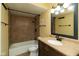 Bathroom featuring a tiled shower, vanity with sink, and updated fixtures at 1131 Canterbury S Sq, Indianapolis, IN 46260