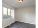Bedroom with a gray wood-look floor, a large window, natural lighting, and neutral paint at 1131 Canterbury S Sq, Indianapolis, IN 46260