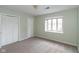 Bedroom with a large window and closet with white doors providing ample storage and natural light at 1131 Canterbury S Sq, Indianapolis, IN 46260