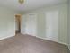 Bedroom with plush carpeting, closet with white doors, and light-filled windows at 1131 Canterbury S Sq, Indianapolis, IN 46260