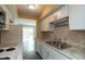 Bright kitchen featuring updated appliances, white cabinetry, and stainless steel sink at 1131 Canterbury S Sq, Indianapolis, IN 46260