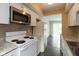 Efficient kitchen featuring white appliances, ample cabinet space, and updated countertops at 1131 Canterbury S Sq, Indianapolis, IN 46260