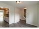 Open concept living space with wood-look floors and seamless transition to the entry and kitchen at 1131 Canterbury S Sq, Indianapolis, IN 46260