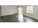 Cozy living space with wood-look floors, a white brick accent wall, and natural light at 1131 Canterbury S Sq, Indianapolis, IN 46260