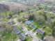 Residential neighborhood with mature trees, varied home styles, and visible swimming pool in backyard at 11423 Mutz Cir, Indianapolis, IN 46229