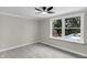Serene bedroom with soft carpet and view of fenced yard from large window at 11423 Mutz Cir, Indianapolis, IN 46229