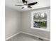 Bright bedroom with a view of the street from the window, ceiling fan, and soft carpet at 11423 Mutz Cir, Indianapolis, IN 46229