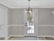 Charming dining area with a modern light fixture and a white door to the backyard at 11423 Mutz Cir, Indianapolis, IN 46229