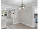 Bright dining area features a modern light fixture and light-filled open floor plan at 11423 Mutz Cir, Indianapolis, IN 46229