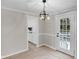 Dining room featuring an updated light fixture and a view into the kitchen at 11423 Mutz Cir, Indianapolis, IN 46229