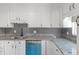 Bright kitchen with white cabinets, granite countertops, stainless sink and sleek mosaic backsplash at 11423 Mutz Cir, Indianapolis, IN 46229