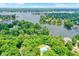 Aerial view of large lake surrounded by homes and trees with pool and tennis courts at 11525 Capistrano Cir, Indianapolis, IN 46236