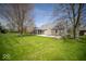 Well-maintained backyard showcasing a screened-in porch and patio area for relaxation at 11525 Capistrano Cir, Indianapolis, IN 46236