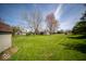 Expansive backyard featuring a lush lawn and mature trees, perfect for outdoor activities at 11525 Capistrano Cir, Indianapolis, IN 46236