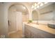 Bright bathroom featuring arched doorway, vanity, mirror and shower with white shower curtain at 11525 Capistrano Cir, Indianapolis, IN 46236