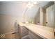 Well-lit attic bathroom featuring vanity with mirror, tile floors and toilet at 11525 Capistrano Cir, Indianapolis, IN 46236
