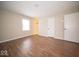 Empty bedroom featuring hard surface floors, with adjacent doors and window providing natural light at 11525 Capistrano Cir, Indianapolis, IN 46236