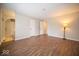 Spacious bedroom featuring neutral walls, wood floors, and ensuite bathroom with arched doorway at 11525 Capistrano Cir, Indianapolis, IN 46236