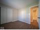 Cozy bedroom with modern flooring and a glimpse into the en-suite bathroom at 11525 Capistrano Cir, Indianapolis, IN 46236