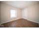 Bright bedroom featuring stylish flooring, a window for natural light, and a convenient closet space at 11525 Capistrano Cir, Indianapolis, IN 46236