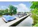 Pontoon boats are docked on a long dock with a wood surface and railings on a sunny day at 11525 Capistrano Cir, Indianapolis, IN 46236