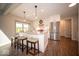 Bright kitchen with white cabinets, stainless steel appliances, and an island with seating for three at 11525 Capistrano Cir, Indianapolis, IN 46236