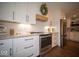 Kitchen featuring white cabinets, stainless steel appliances, and an updated stove at 11525 Capistrano Cir, Indianapolis, IN 46236