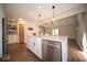 Charming kitchen with stainless steel appliances, white cabinets, and an island with seating at 11525 Capistrano Cir, Indianapolis, IN 46236
