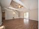Spacious living room with high ceilings, a staircase, hardwood floors, and sliding glass doors to the backyard at 11525 Capistrano Cir, Indianapolis, IN 46236